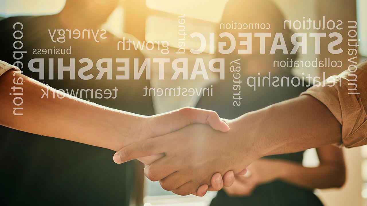 A close up of two people shaking hands with words like strategic, 增长, and partnership overlaid in light text on the image